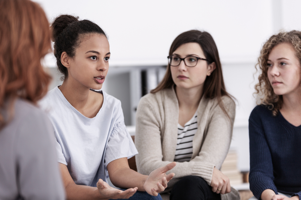 Women Supporting Each Other in Group Therapy Session
