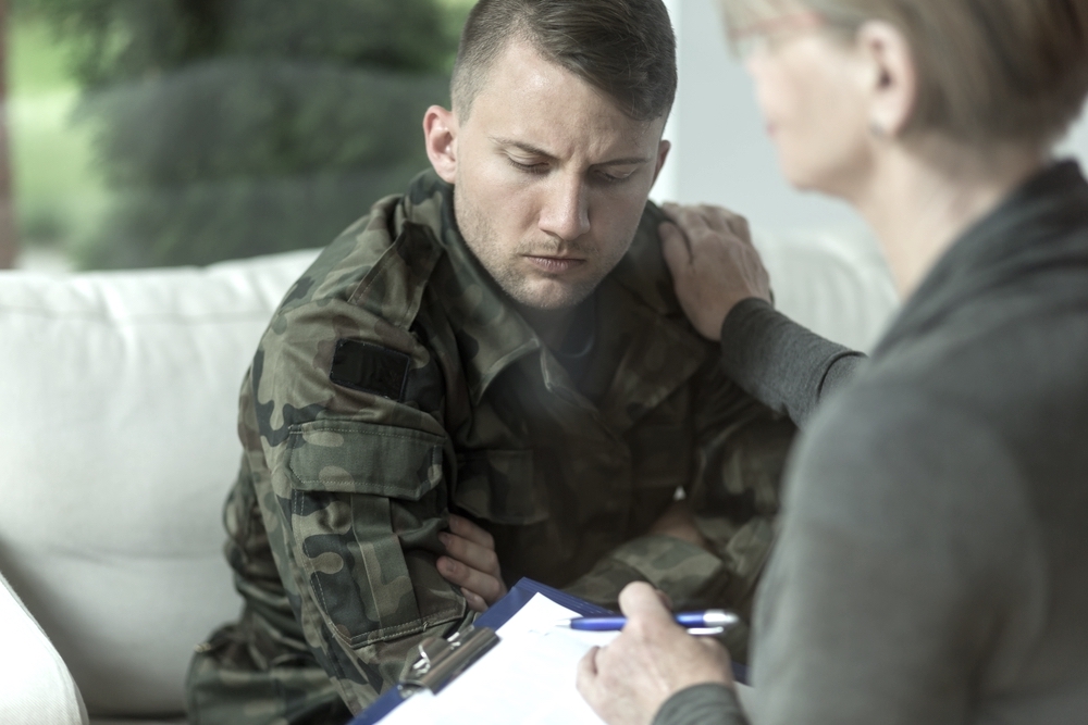 Psychiatrist and despair military man during therapy